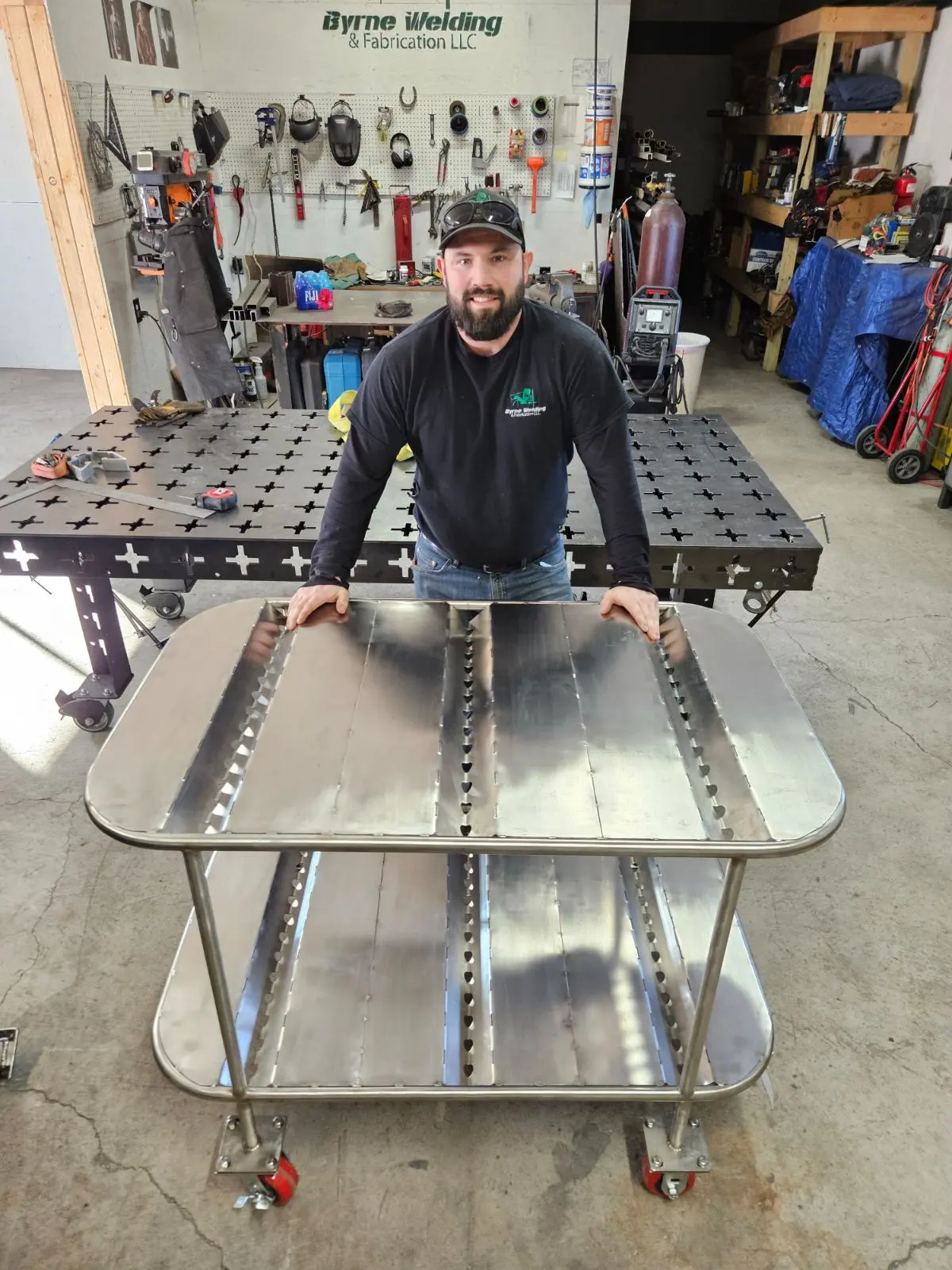 Bryan Byrne in the Byrne Welding & Fabrication shop with a custom stainless cart